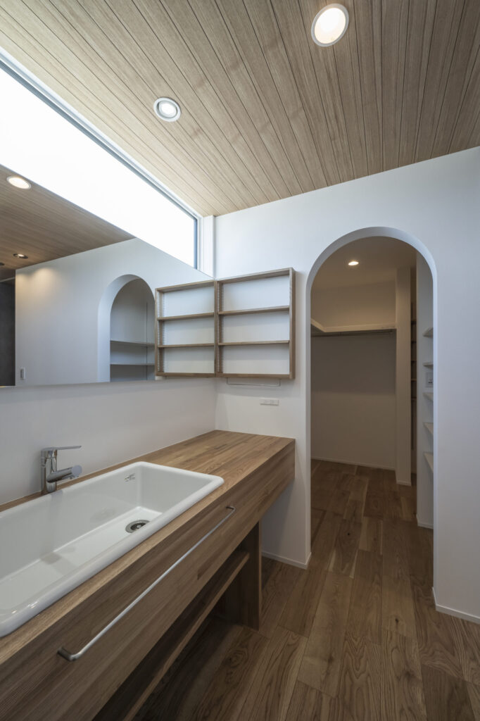 アーチ開口が印象的な洗面と収納動線